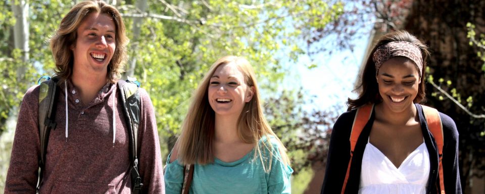 NAU students walking through campus smiling