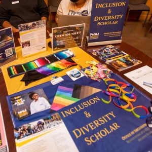 A table is covered with items promoting the ID Scholars program