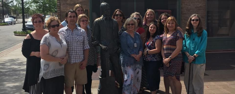 photo of DR and Equity and Access staff standing on a corner in Winslow Arizona