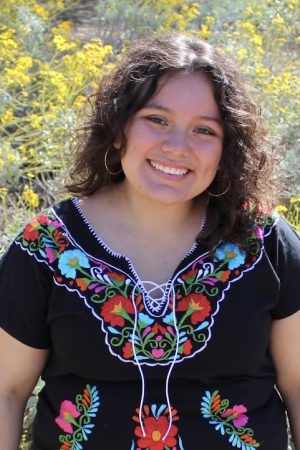 Picture of Emily with colorful embroidered shirt