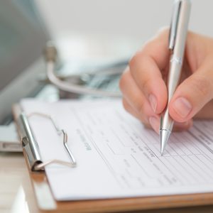 closeup shot of a form on a clipboard being filled out