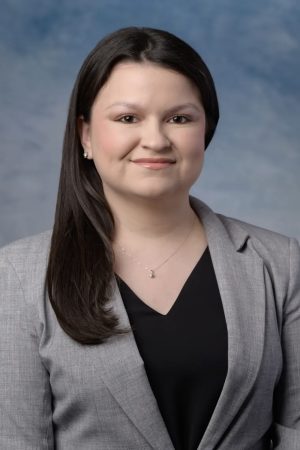 Photo of Codi Sanchez, long dark hair wearing a black v-neck shirt and gray blazer