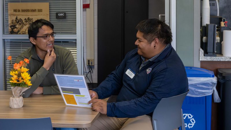 Student staff talking with professional staff in the Veteran Success Center