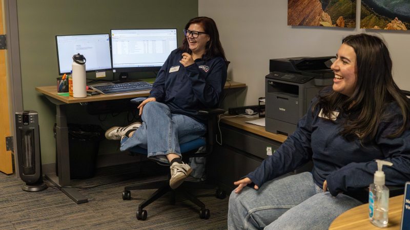 Students laughing at the Veteran Success center front desk