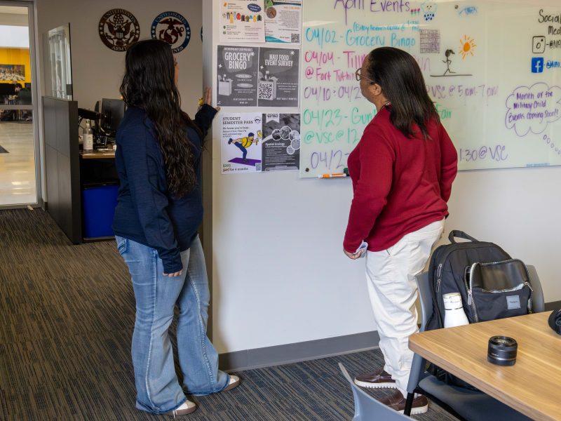 VMS staff and student discussing an even in the VMS center