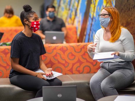 Two NAU students study together in a lounge.