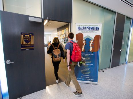 Two students walking into the Health Promotion Office