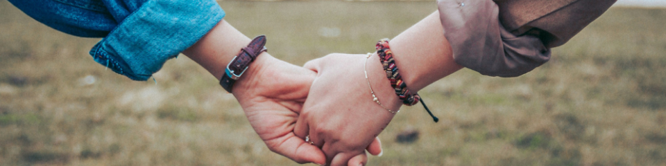 Two people holding hands