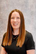 A picture of a woman with pale skin and long brown hair.