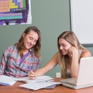 Student and instructor working on a paper
