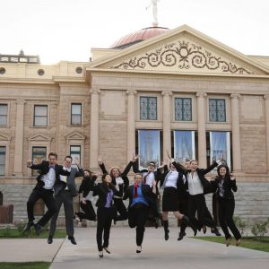 Legislative interns jumping outside of capitol building