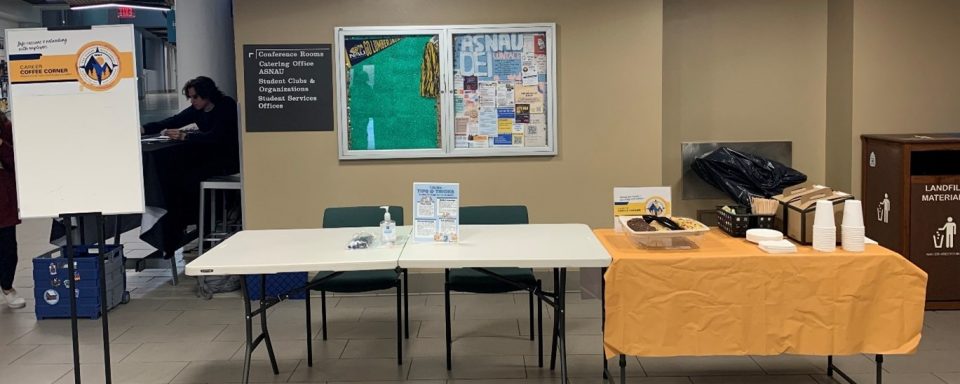 Standard setup for career coffee corner. Two tables, catering, signage.