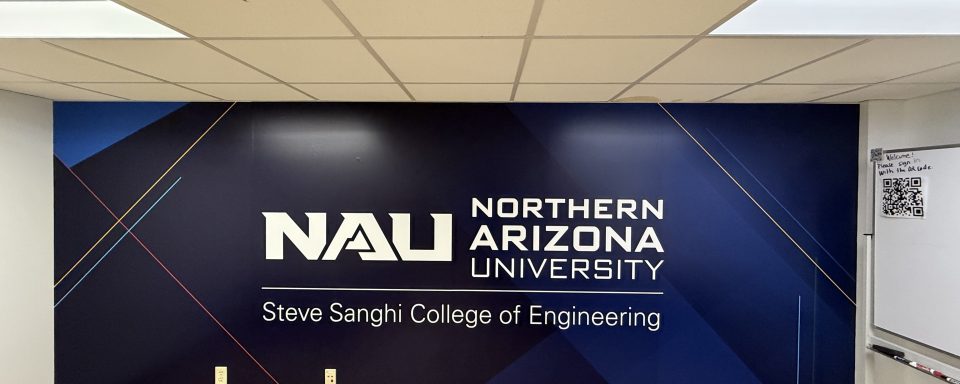 Image of a full adhesive vinyl wall wrap that includes a designed background and an NAU logo as a center focus.