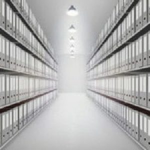 A hallway of binders on shelves in an archive