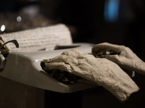Sculpture of hands on type writer in exhibit