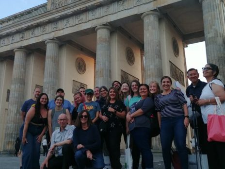 teachers on footsteps trip pose in front of monument