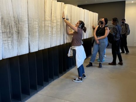 Travlers with large book of names at Auschwitz-Birkenau