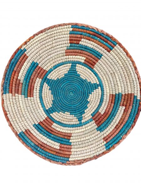 Copper and turquoise Native American basket with star in the center and right angle designs surrounding it