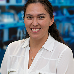 Photo of Bethany Davis with her hair pulled back and wearing a white button up