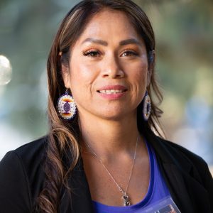 Cellina Reyes wearing a blue top and beaded earrings