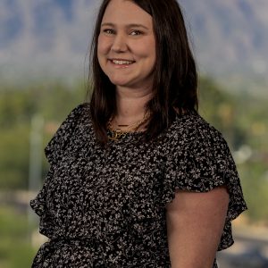 Cassandra Webb wearing a floral top and gold necklace