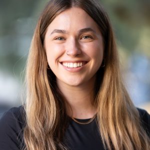 Dana Doyle wearing a black top and gold necklace
