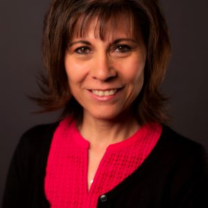 Georgia Yee wearing a bright red-pink top and black cardigan