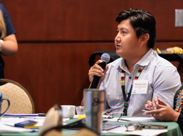 Michael Sam speaking at AICHEF 2025