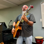 City Councilman Anthony Garcia introduces himself to students with a protest song.