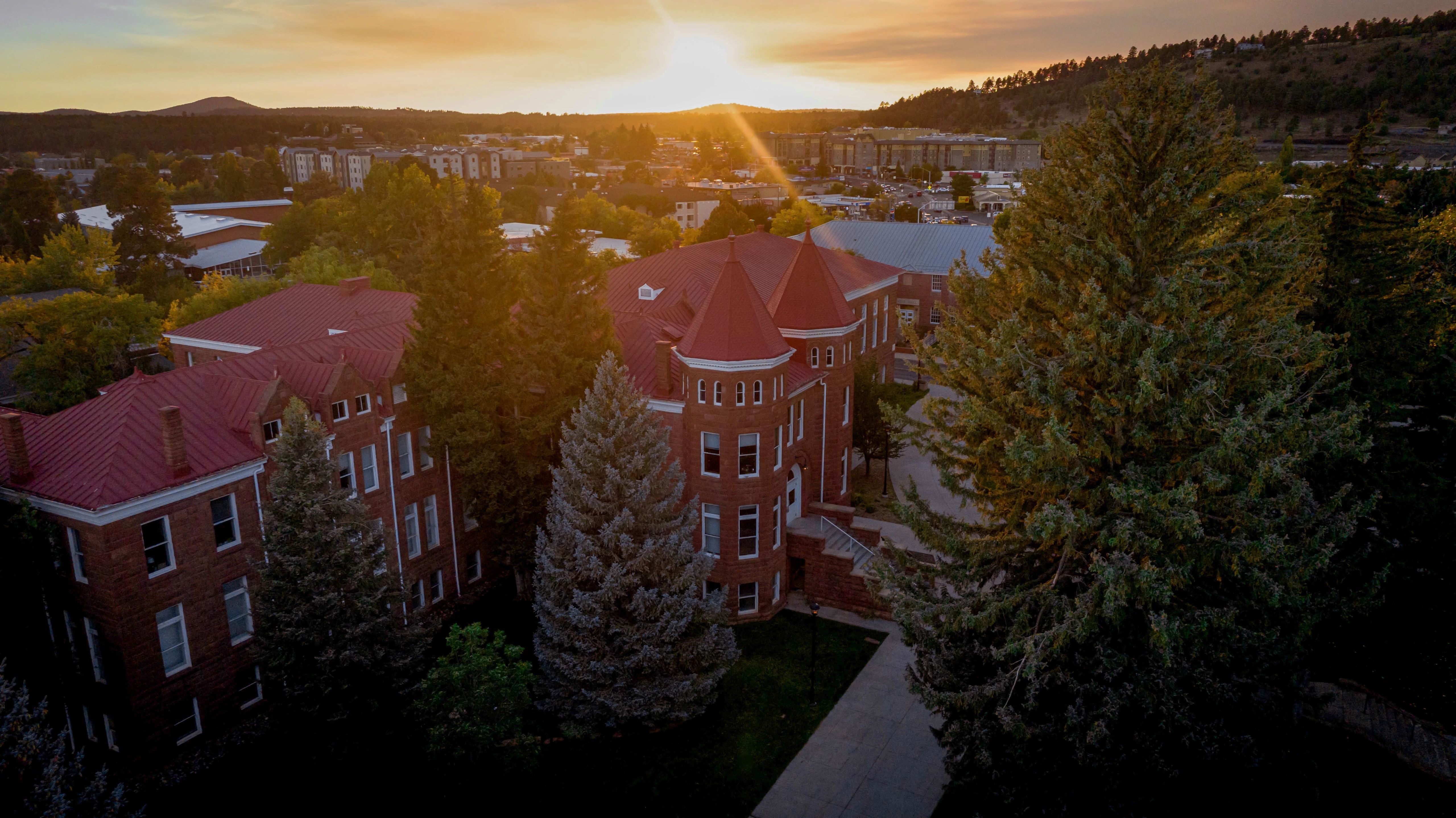 Drone shot of Flagstaff campus buildings at sunset.