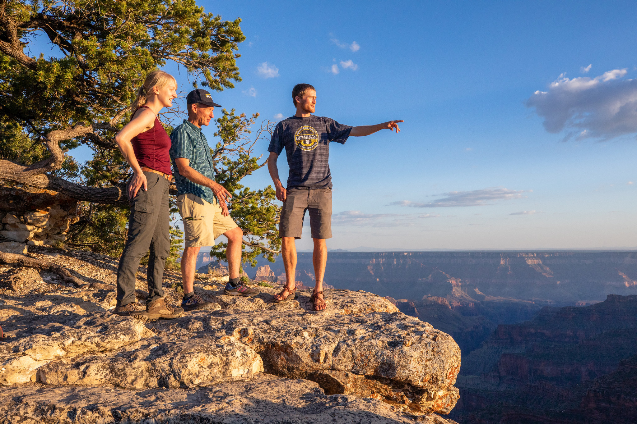 Professor and students standing next to a cliffside at the Grand Canyon.