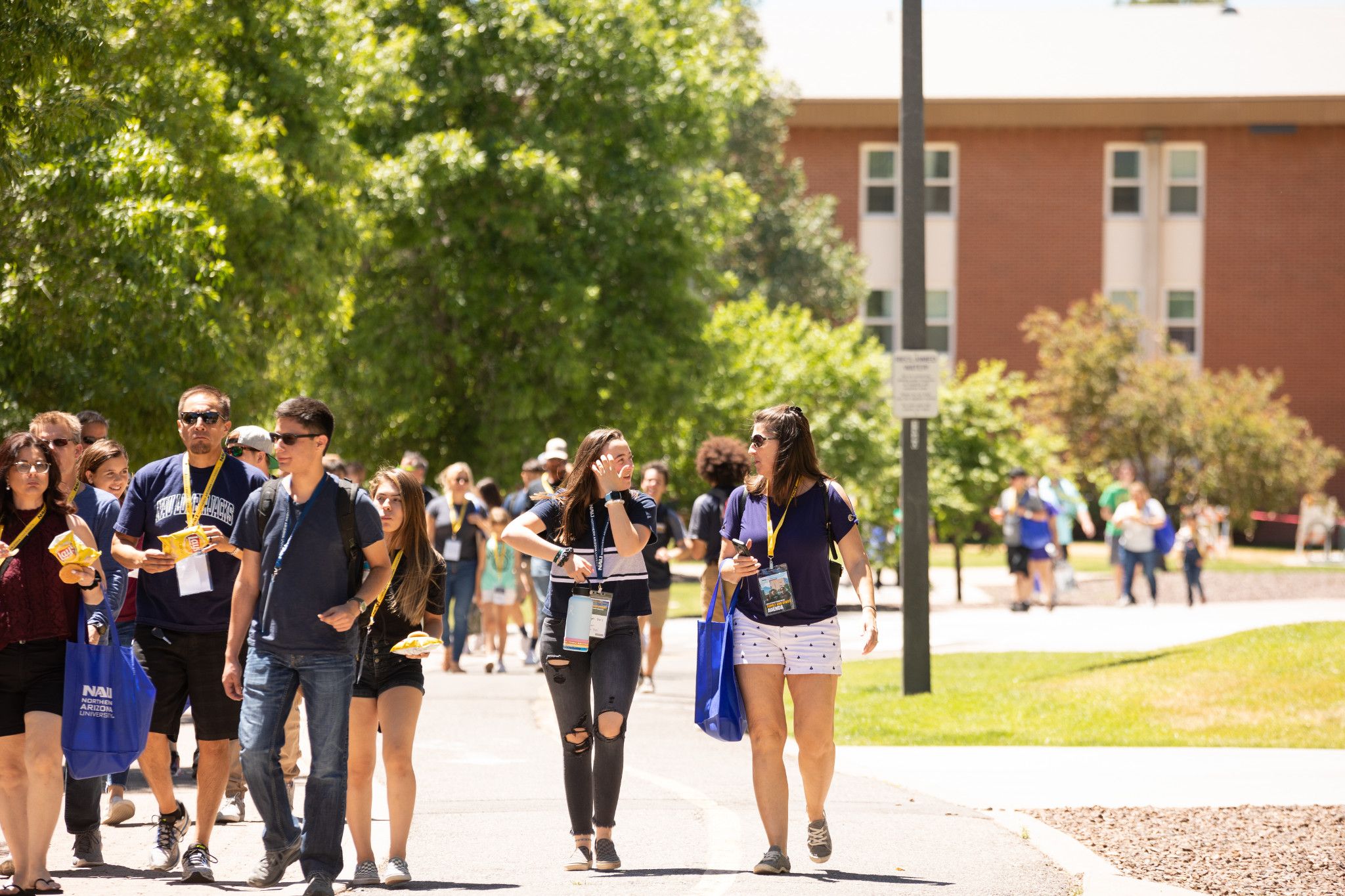 New students and their families walking through campus during orientation day.