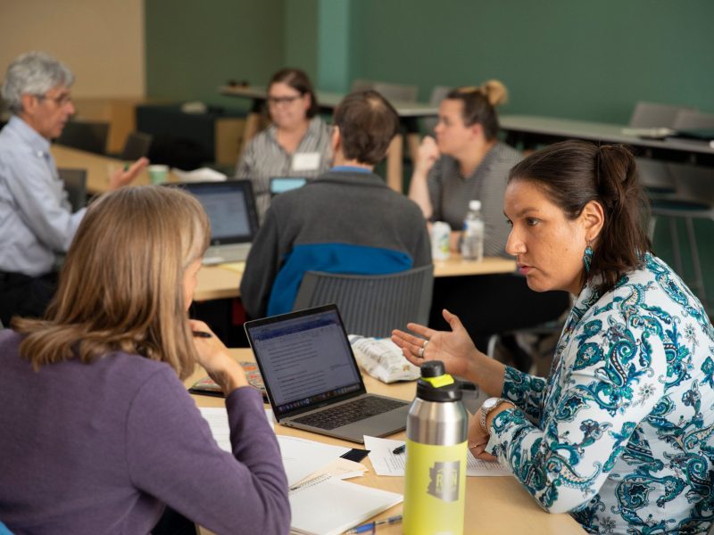 faculty staff speaking with each other