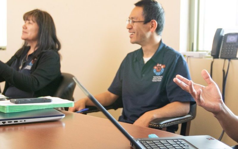 Jordan Ojeda in room with university partners working to improve cancer screening rates on northern Arizona tribal land.