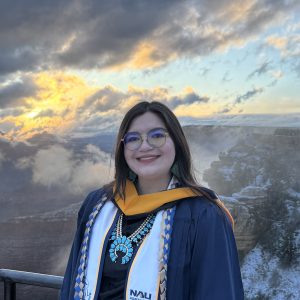 Kaylin McLiverty pictured in front of a cloudy sky.