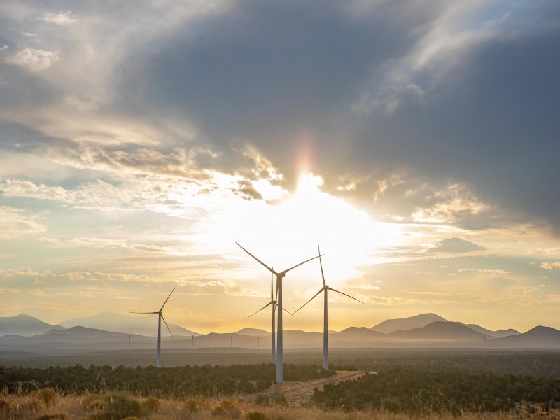 Photo of Wind Farm and mountains in the background.