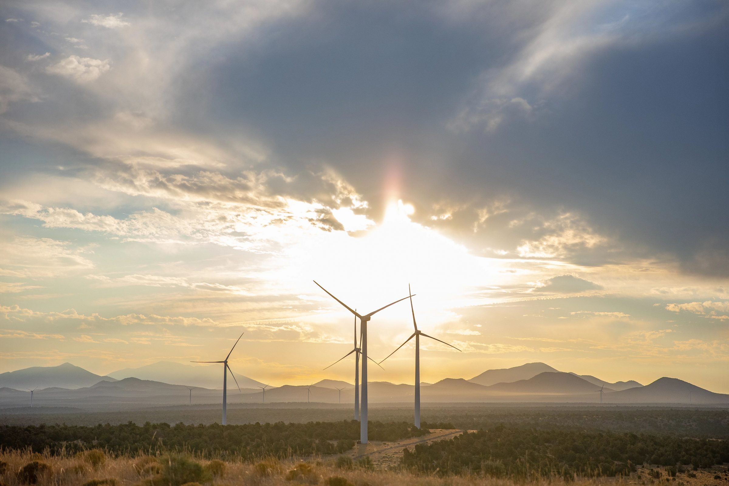 Photo of Wind Farm and mountains in the background.