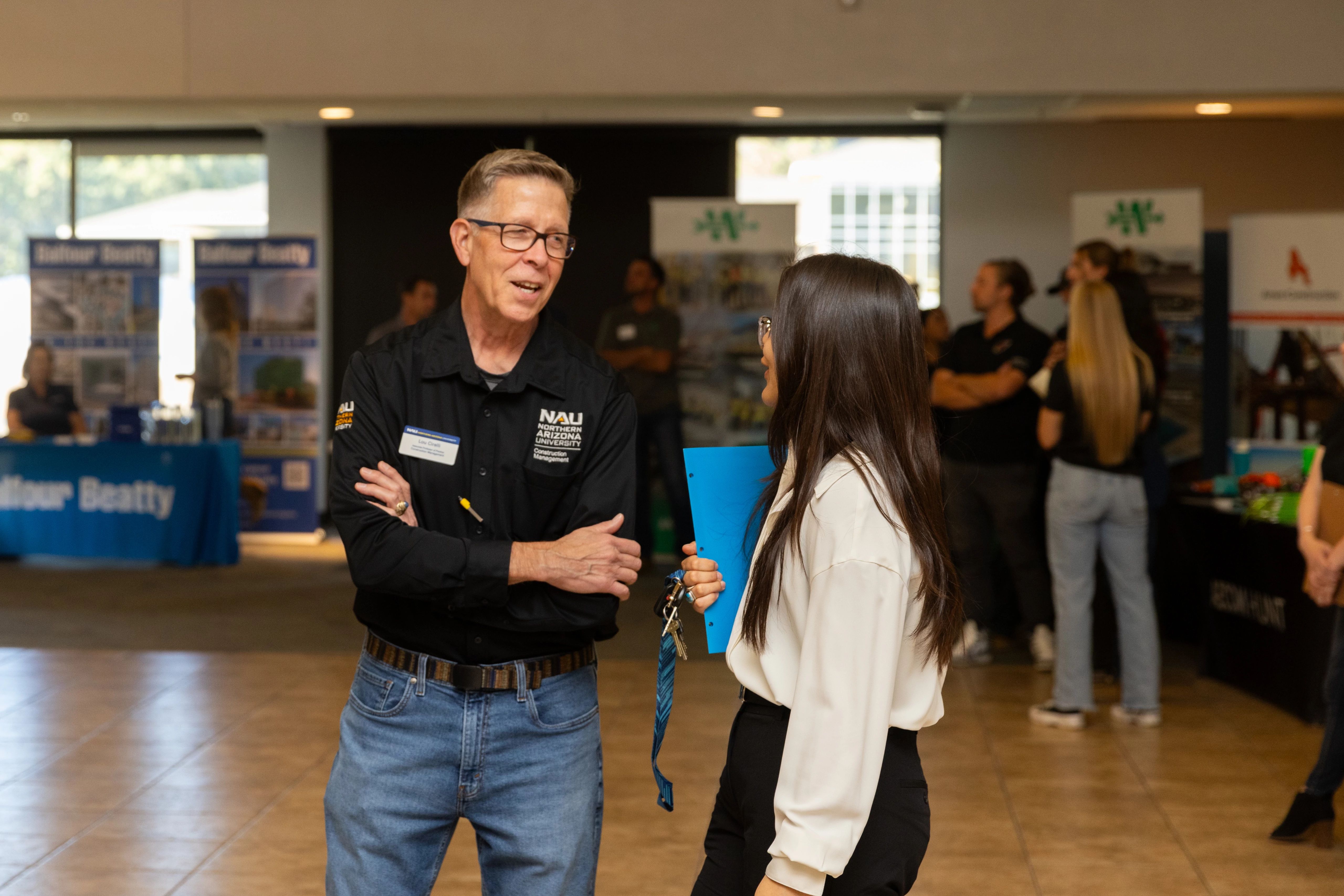 Student talking to an employer at a career fair.