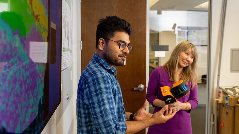 Students demonstrating how to use a device.