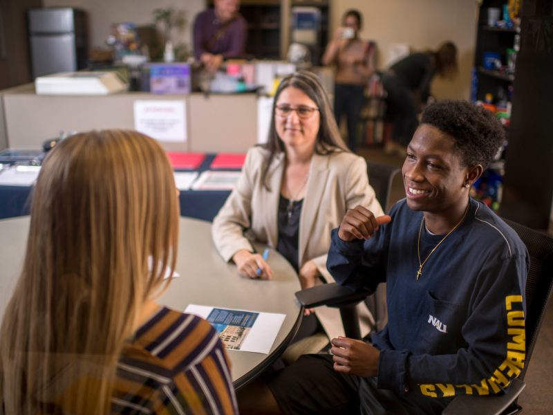A student meets with potential employers.