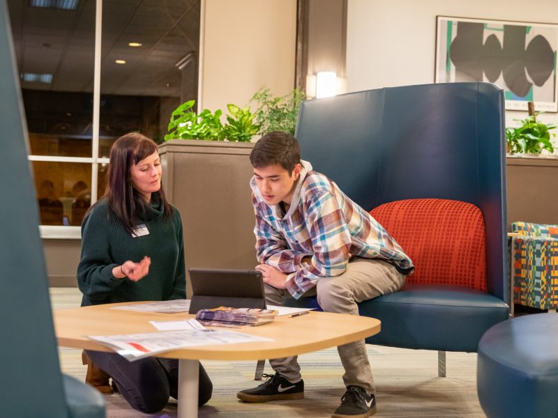 Advisor helping out a student in a resident hall.