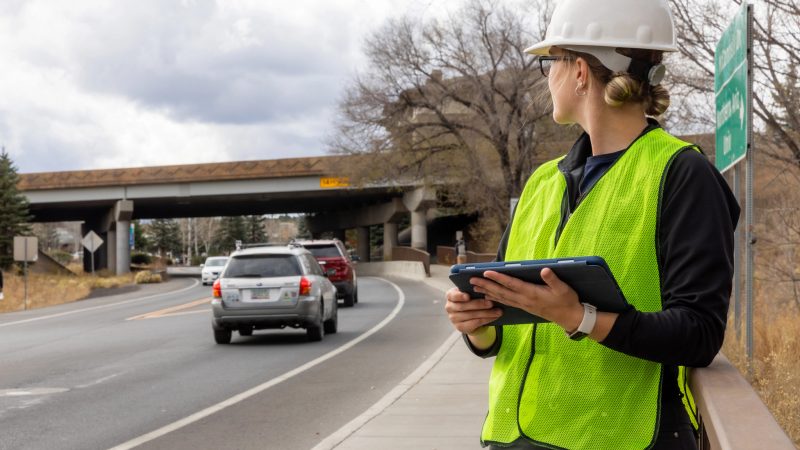 Student performing an outdoors survey on McConnell Dr.