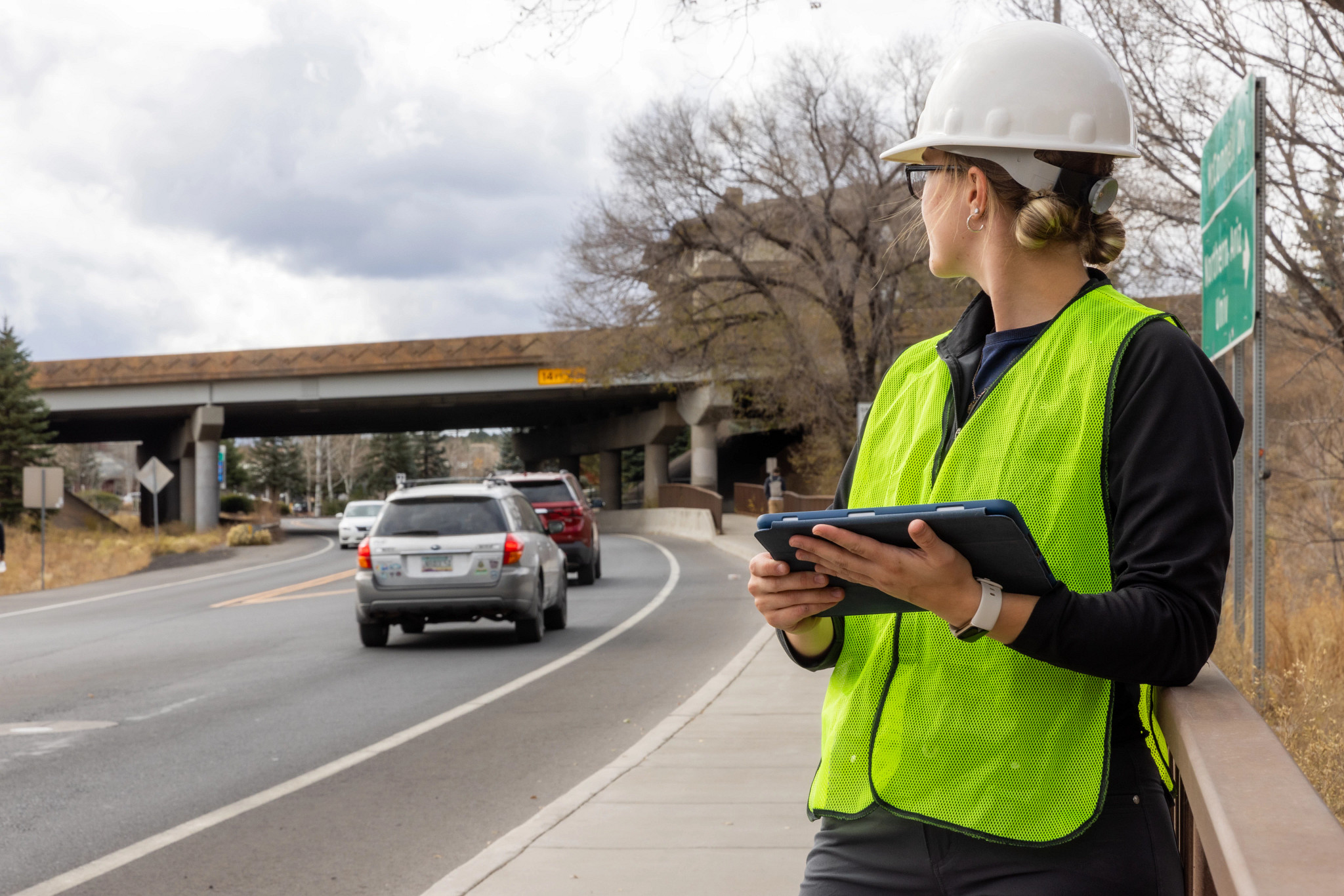 Student performing an outdoors survey on McConnell Dr.