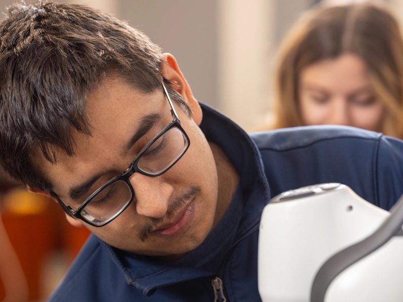 Student working on a piece of equipment.