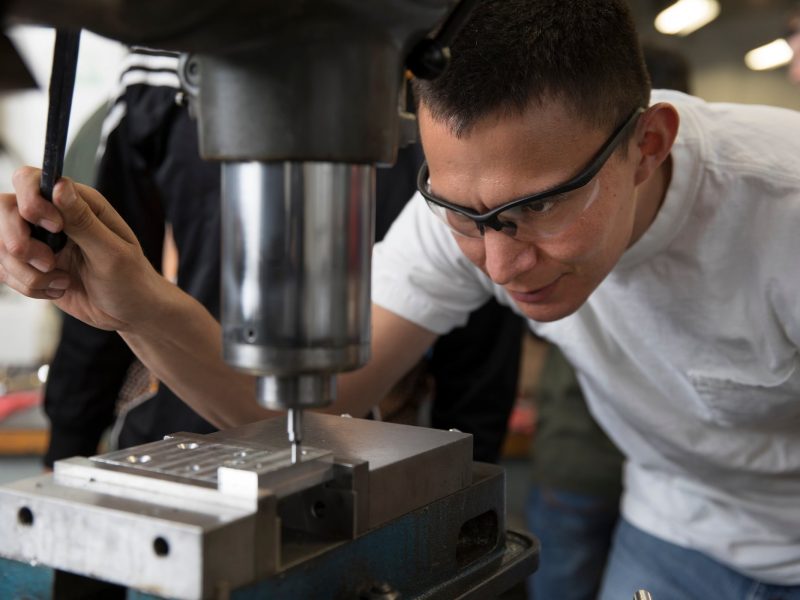 Jonathan Witherspoon works with machinery.