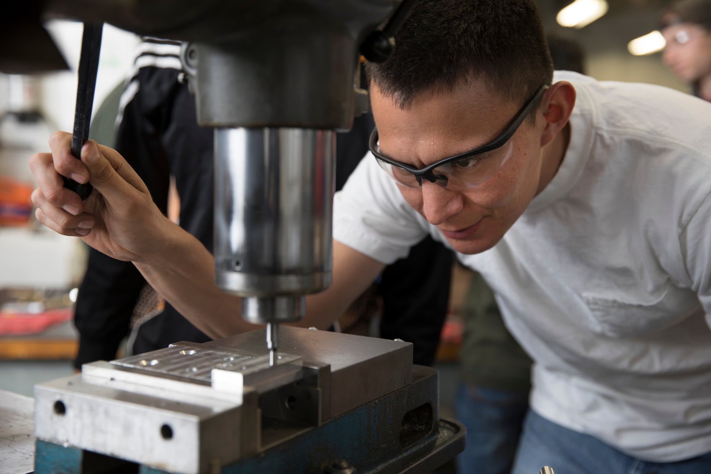 Jonathan Witherspoon works with machinery.