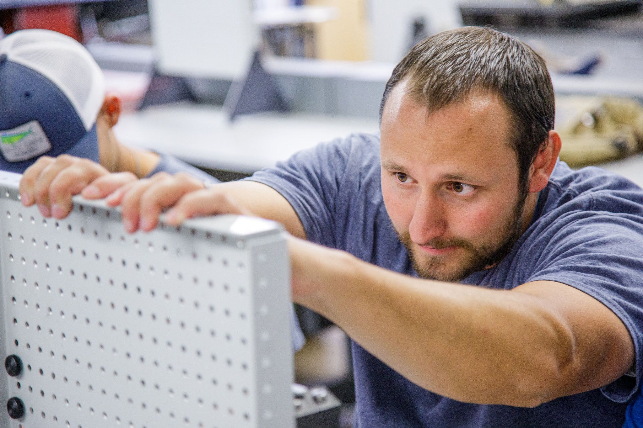 Student working carefully on a metal board.