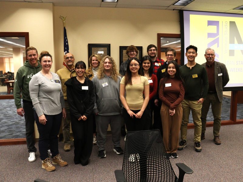 A group of people stands in front of NAU Venture Studio