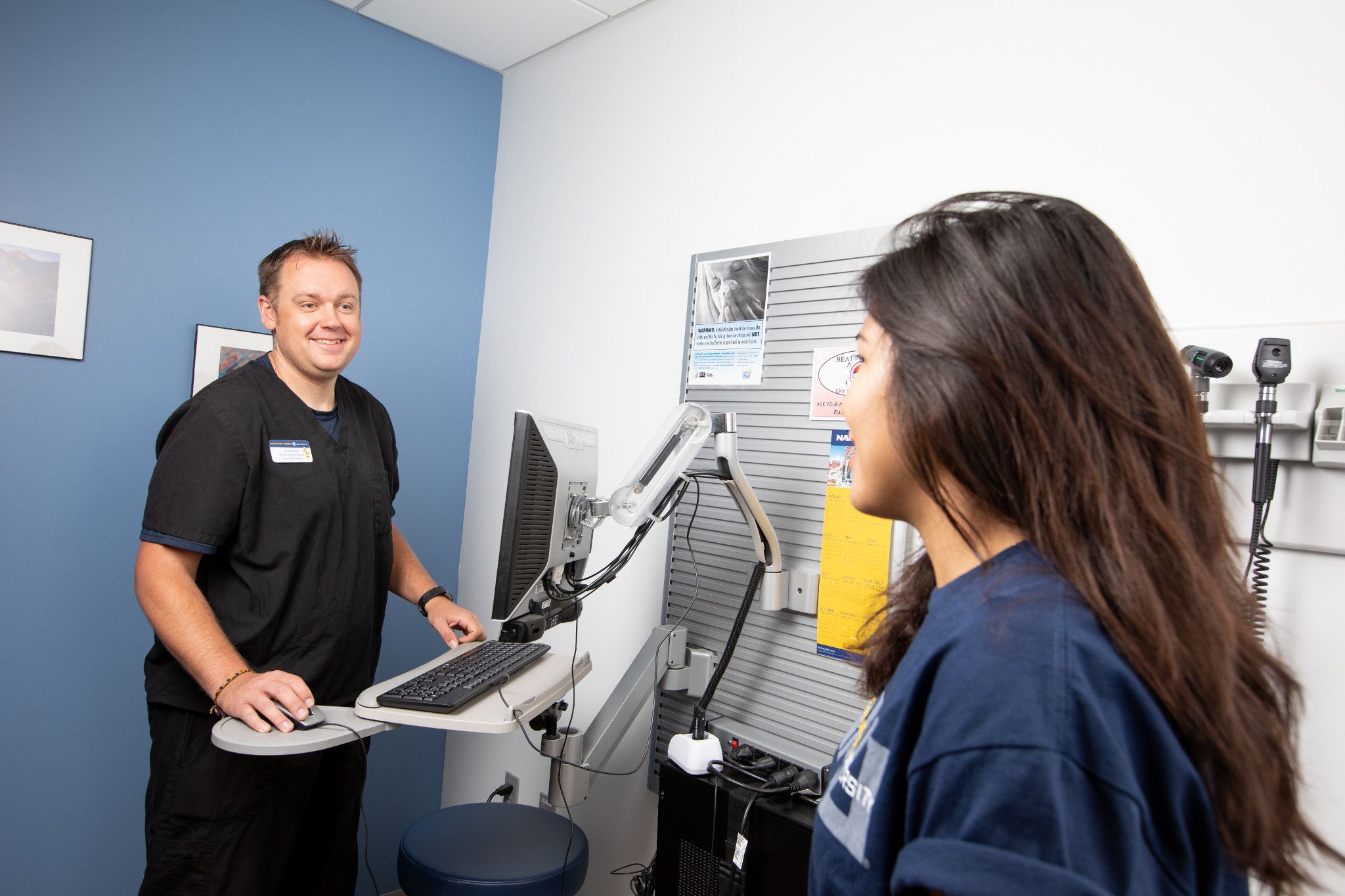 Student talking to campus health services staff.