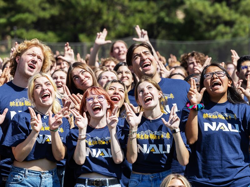 Group of freshmen posing with the Jacks hand symbol for the camera.